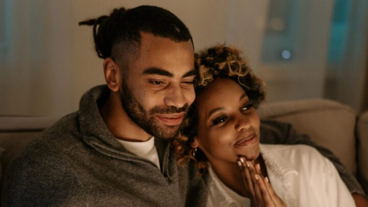 couple on couch watching tv - thanks to the success of a tune-in podcast sponsorship campaign?