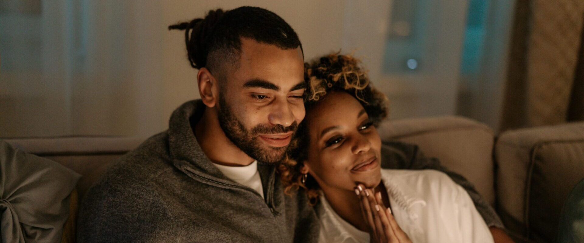 couple on couch watching tv - thanks to the success of a tune-in podcast sponsorship campaign?
